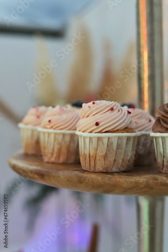 Delicious sweet cupcakes with cream at the party.