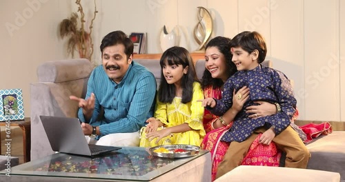 Happy family members talking on video call on laptop 
