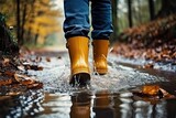 Close up of yellow rubber boots walking through puddle in park or forest in autumn. Generative AI