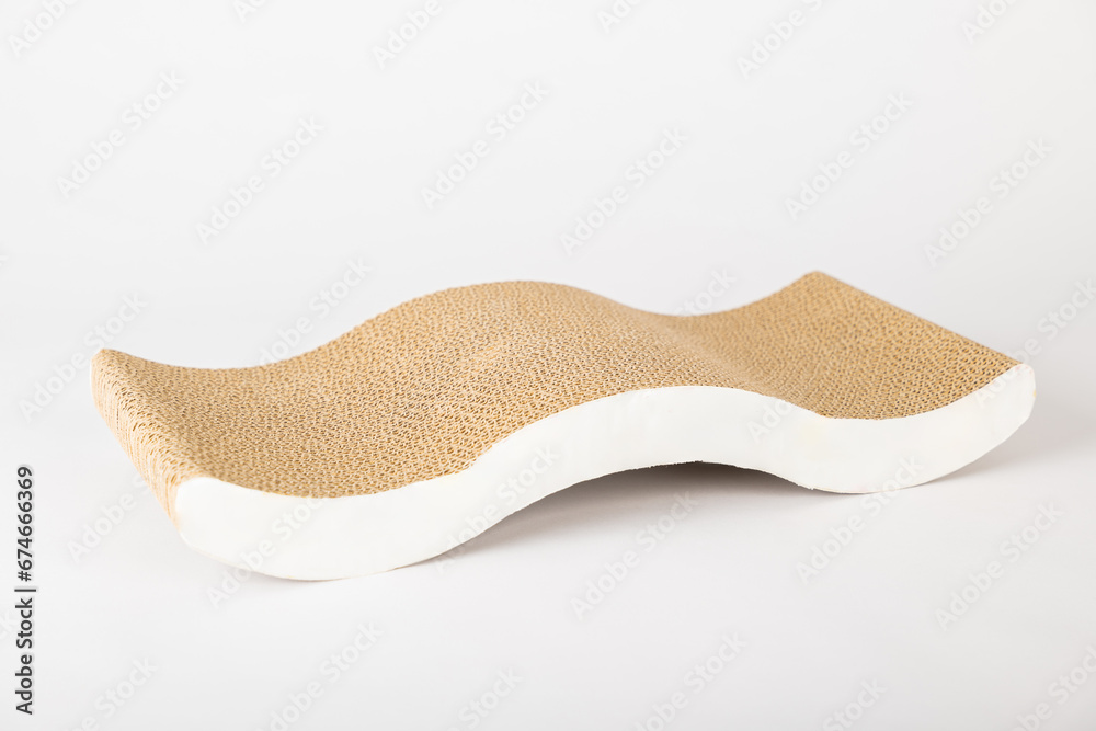 A cat's alertness and curiosity are evident as it explores a modern abstract cat scratching post which doubles as a comfy lounge bed. The corrugated cardboard design is a staple for feline furniture. A cat's alertness and curiosity are evident as it explores a modern abstract cat scratching post which doubles as a comfy lounge bed. The corrugated cardboard design is a staple for feline furniture.