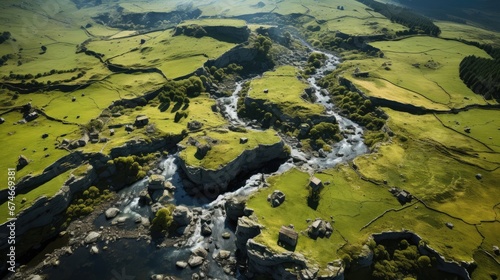 Aerial view of vibrant green mountain landscape intersected by river