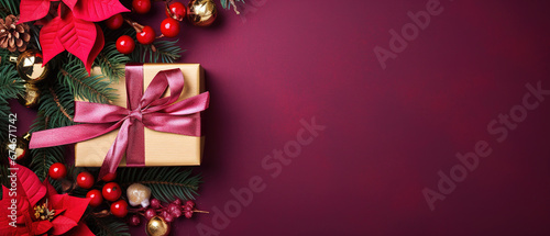 purple christmas background with poinsettia with leaves, red berries, gift box wrapped red silk ribbon, gold tinsel, with empty copy Space