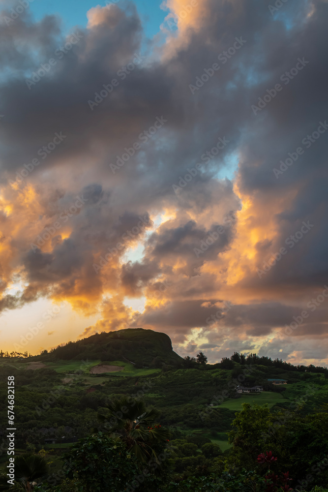 Evening view of ridge with dramatic clouds near Kilauea, Kauai, Hawaii, United States.
