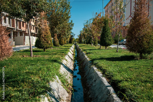 It is divided into two sides with a canal in the middle and beautiful greenery on both sides of it