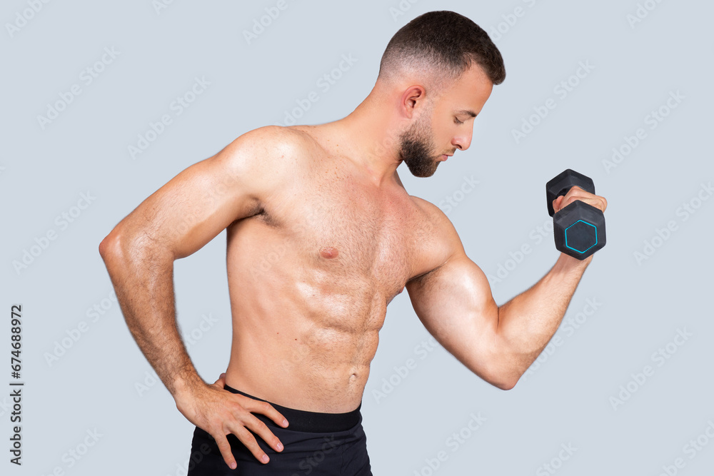 Concentrated calm sweat handsome strong muscular millennial caucasian guy with beard, naked torso make exercises