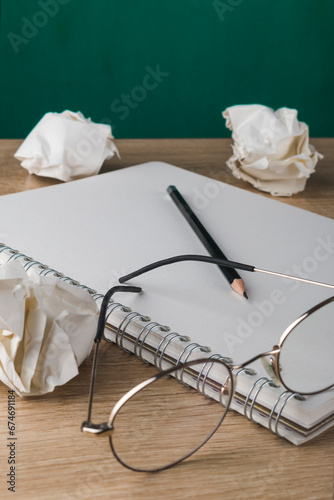 sketchbook with blank sheets on a wooden table with paper bags and glasses, concept of ideas in a notebook, making notes, back to school, art photo