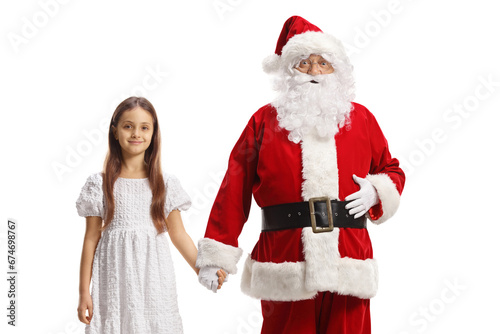 Santa claus holding hand of a girl in a white dress