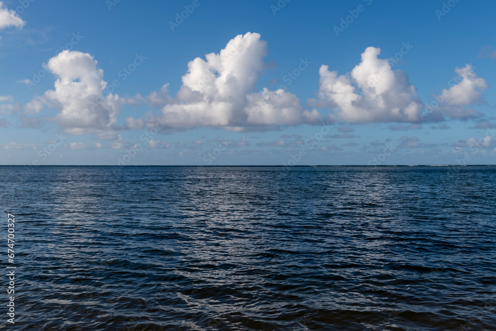 Fototapeta premium Beautiful white clouds above the Pacific Ocean in Kauai, Hawaii, United States. 