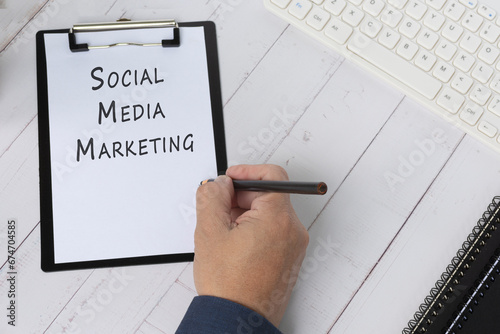 Words Social Media Marketing on a paper with black clipboard.