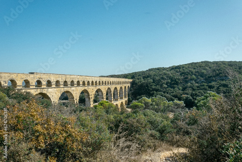 pont du gard aqueduct surrounded by nature in a landscape