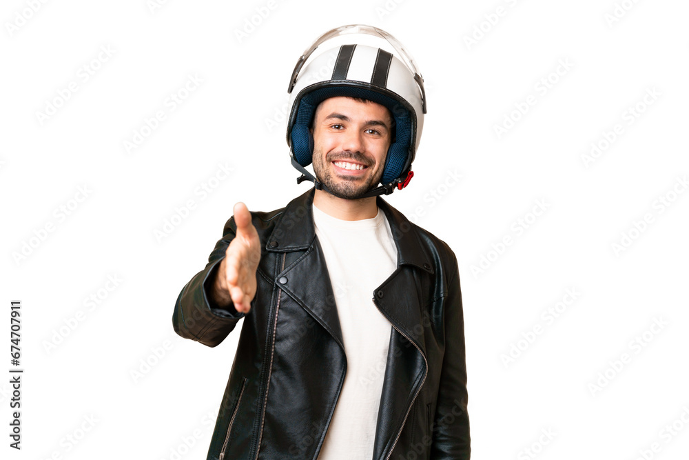Young caucasian man with a motorcycle helmet over isolated chroma key background shaking hands for closing a good deal Young caucasian man with a motorcycle helmet over isolated chroma key background shaking hands for closing a good deal