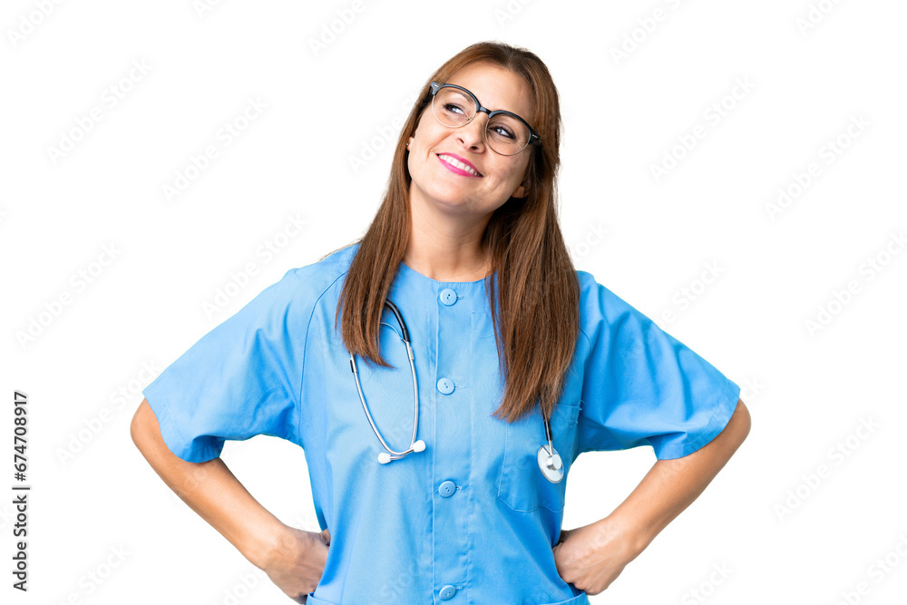 Middle age nurse woman over isolated background posing with arms at hip and smiling Middle age nurse woman over isolated background posing with arms at hip and smiling