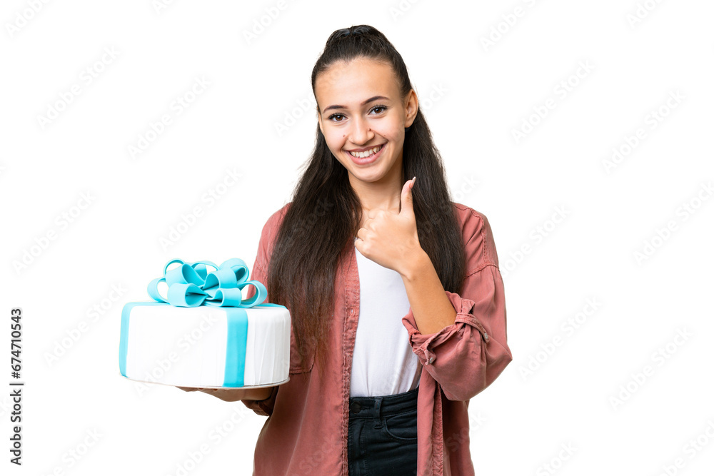 Young Arabian woman holding birthday cake over isolated chroma key background giving a thumbs up gesture Young Arabian woman holding birthday cake over isolated chroma key background giving a thumbs up gesture