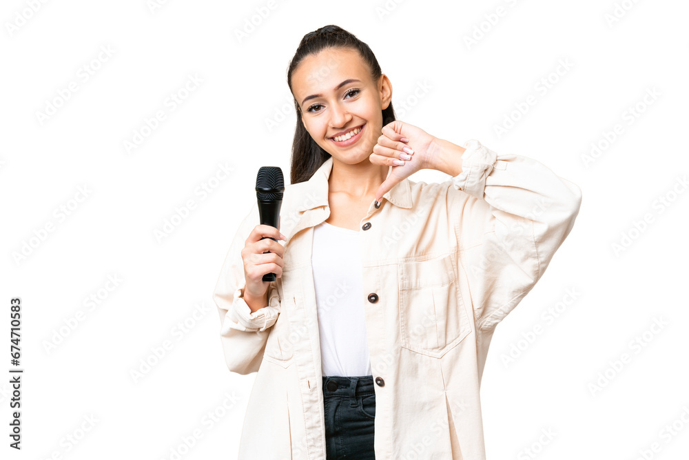 Young singer woman picking up a microphone over isolated chroma key background proud and self-satisfied Young singer woman picking up a microphone over isolated chroma key background proud and self-satisfied