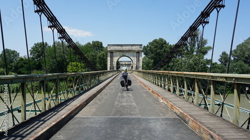 Принти на полотні A bicycle on the Vieux Pont Le Petit Rhone looking direction Fourques in the dep