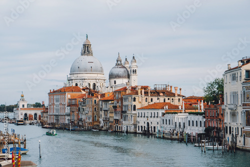 Famous view of Venice Grand Canal with Saint Mary of Health dome on sunny day from Ponte dell Accademia bridge. Italian travel destination and landmark  tourist attraction.