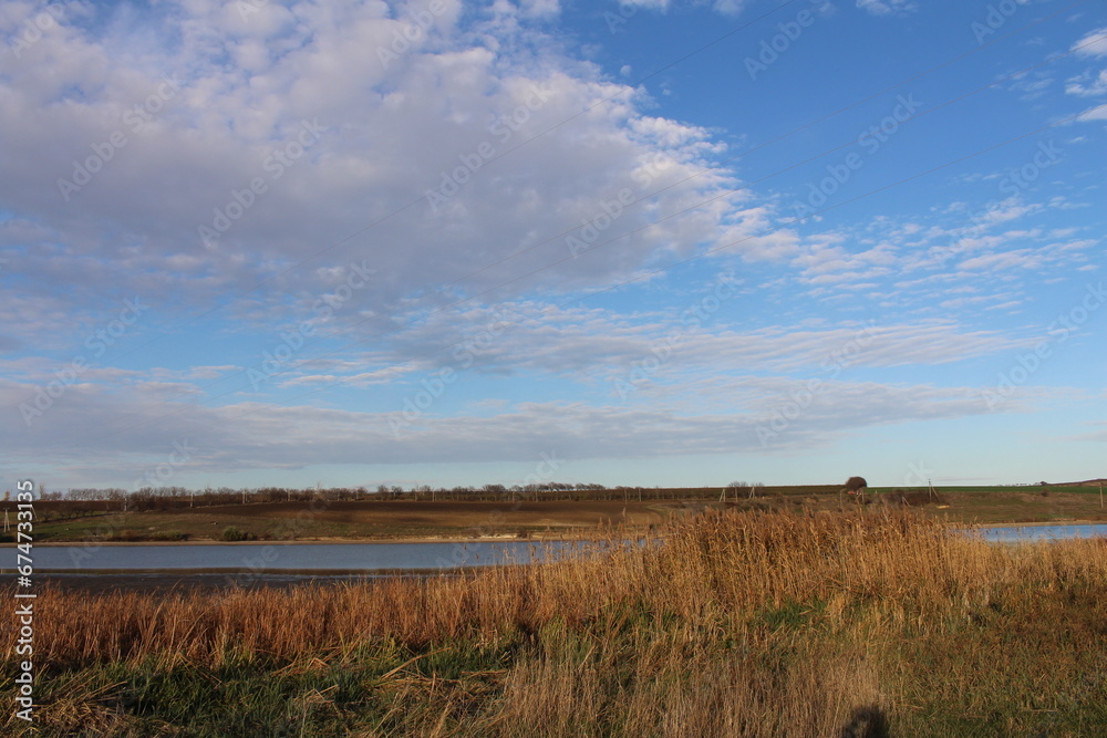 A field with grass and a body of water in the distance A field with grass and a body of water in the distance