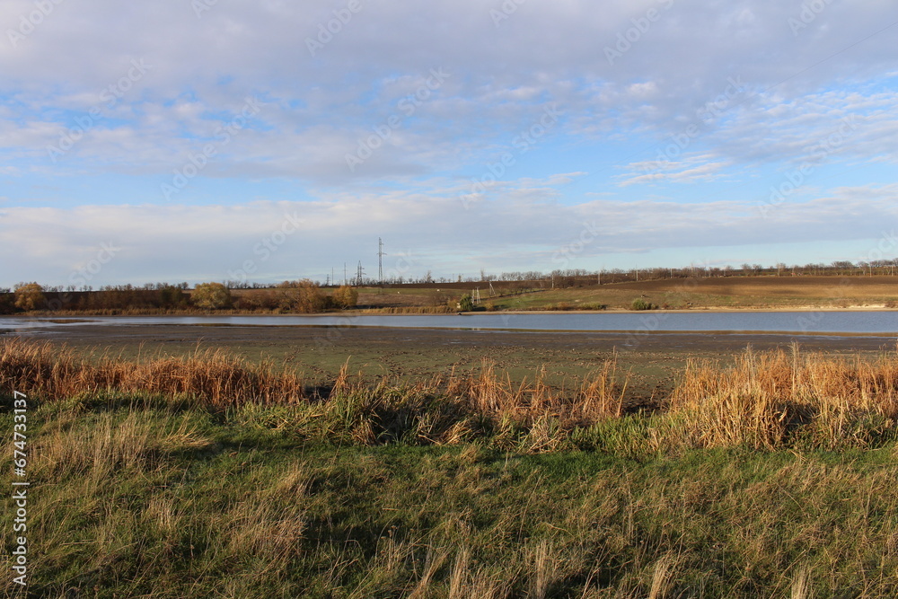 A river with grass and trees in the background