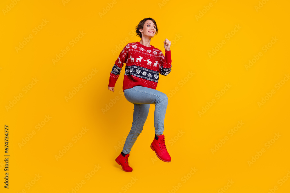 Fototapeta premium Full body photo of excited gorgeous woman wear red sweater run shopping look at sale empty space isolated on yellow color background