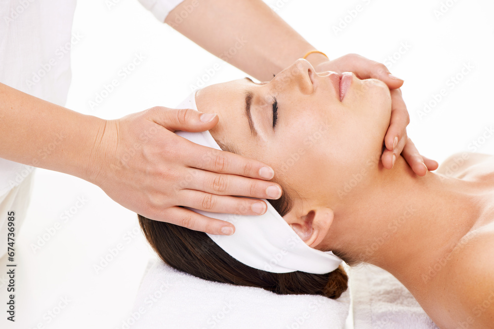 Spa, hands and face massage with a woman customer in studio isolated on a white background for stress relief. Head, luxury treatment and a young person at the salon for health, wellness or to relax