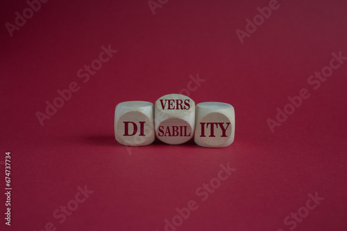 Diversity or disability symbol. Concept words Diversity disability on wooden cubes. Beautiful red background. Business diversity disability concept. Copy space.