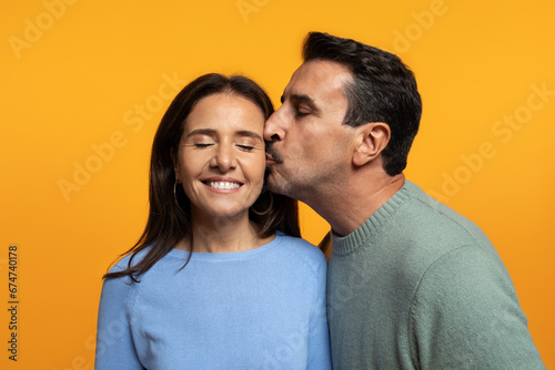 Portrait of happy old caucasian husband kiss in chick wife, enjoy free time