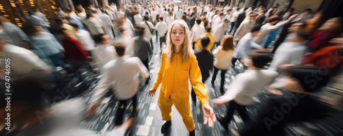 Standing out from the crowd with young woman in yellow clothes looking at camera