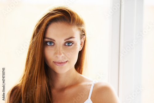 Hair care  portrait or happy woman by window with beauty  skincare or results for glow  shine or collagen. Smile  face or female model with cosmetics for treatment  healthy texture or growth in home