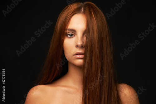 Hair care, portrait or woman with beauty, skincare or results for glow, shine or collagen in studio. Black background, face or serious model with cosmetics for treatment, healthy texture or growth