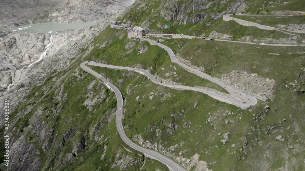 Aerial view of a cars driving on a serpentine road in the swiss alps, Furka Pass, Switzerland. Aerial view of a cars driving on a serpentine road in the swiss alps, Furka Pass, Switzerland.