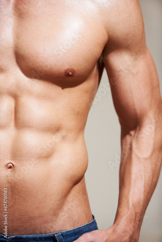 Bodybuilder, strong and muscle with stomach, sexy and shirtless for body, six pack and model in studio background. Athlete, workout and wellness for abs, chest or fit for health, exercise or training