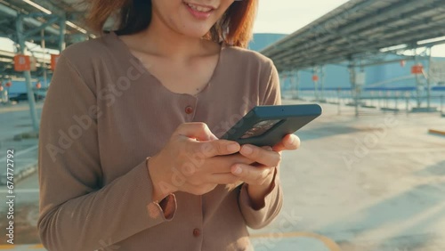 Close up of beautiful Asian woman using a smartphone wearing a casual outfit in the shopping mall. Female in a casual lifestyle concept.