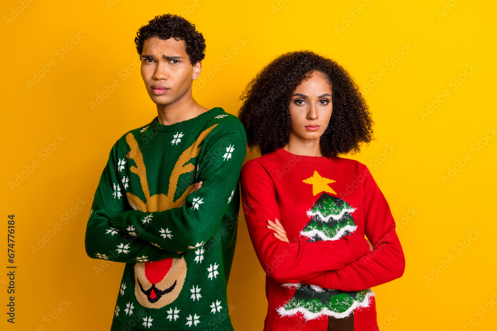 Photo of stressed unhappy guy girl dressed christmas ugly print pullover arms folded dislike outfits isolated yellow color background