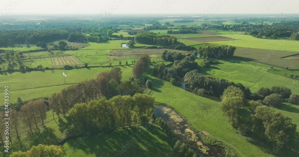 Aerial view of meandering river Roer surrounded by trees and meadows, Roerdal, Paarlo, Sint Odilienberg, Limburg, Netherlands. Aerial view of meandering river Roer surrounded by trees and meadows, Roerdal, Paarlo, Sint Odilienberg, Limburg, Netherlands.