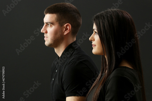 Studio portrait of young couple on the black background