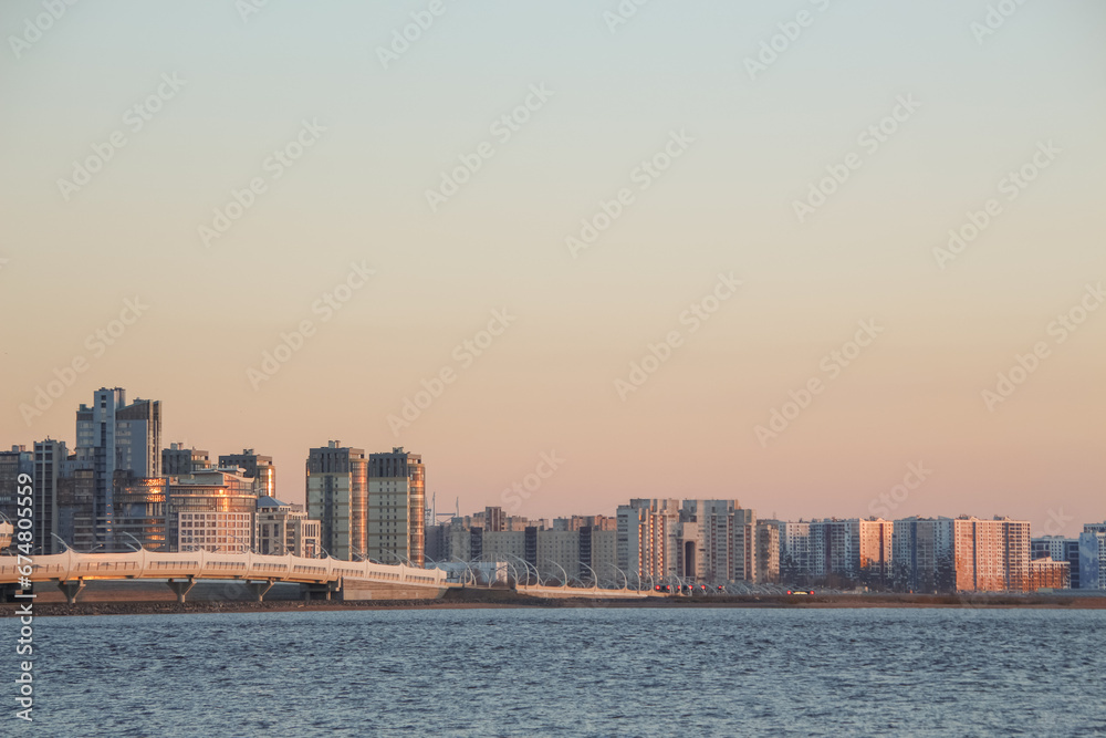 Fototapeta premium Architecture of the city skyline on the seashore at sunset