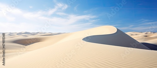 On a summer vacation in Egypt people are amazed by the white sand dunes that stretch across the desert landscape harmoniously blending with the blue sky and creating a breathtaking backgroun