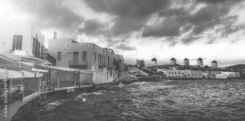 Beautifuk sunset view of Mykonos seafront with windmills, black and white photo photo