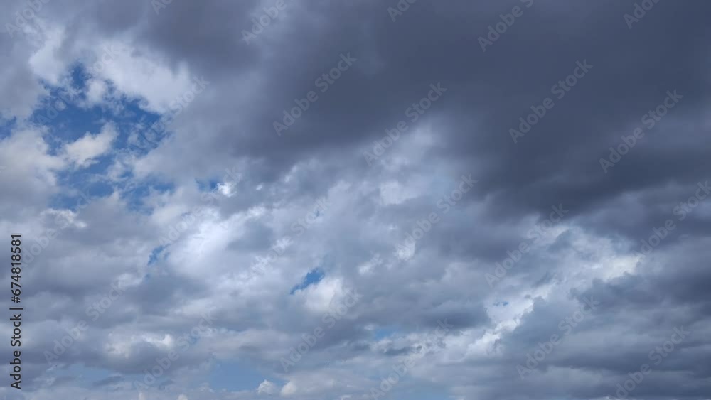 White cumulus clouds drive away dark clouds in the afternoon White cumulus clouds drive away dark clouds in the afternoon