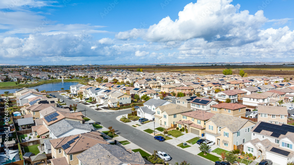 Drone photo of a community in Oakley, California with houses, cars, streets and solar