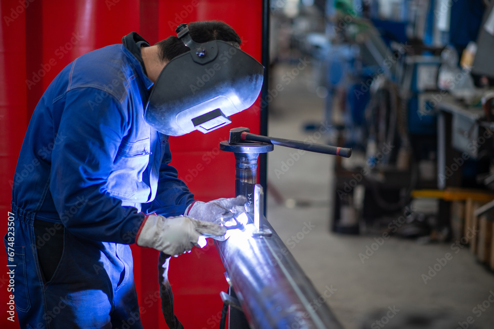 Welder at work in a facility Welder at work in a facility
