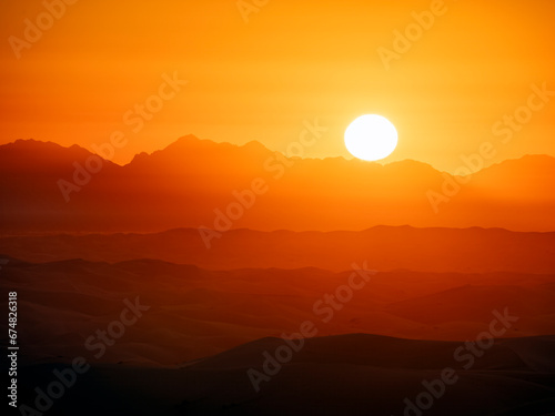 California monochromatic sunrise with gradients over mountains and desert sand dunes