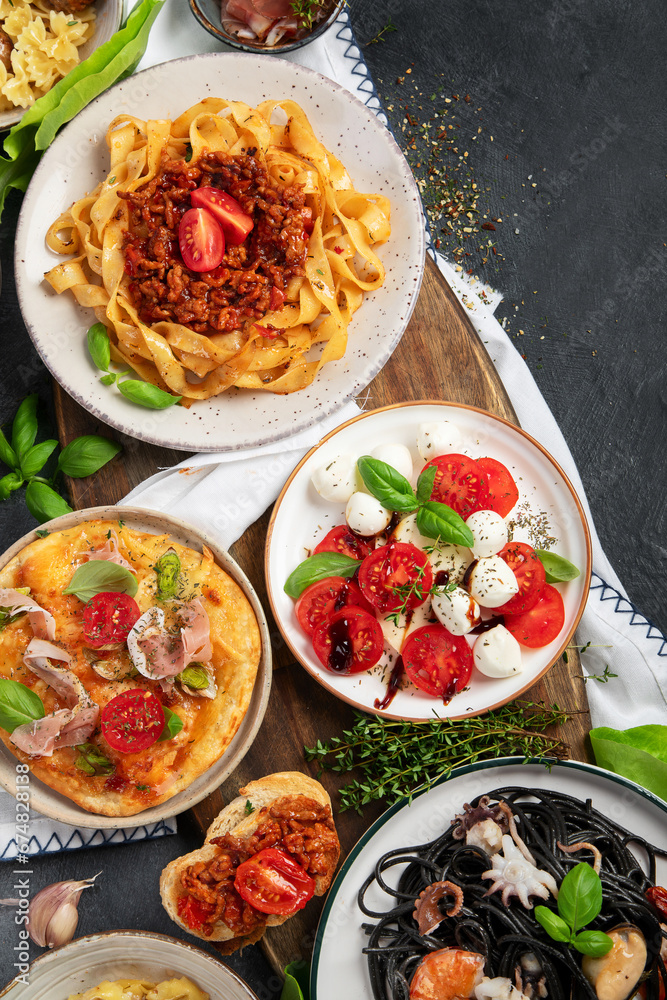 Italian food dishes on dark background. Traditional food concept. Italian food dishes on dark background. Traditional food concept.