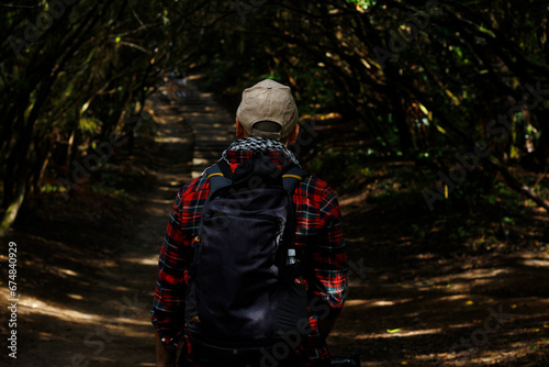 Hiker walking in the forest photo