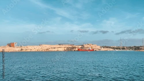 Fort Rikazli or Fort Ricasoli, Kalkara view from the sea. Gladiator arena in the middle of the fortress. Slow motion . High quality 4k footage photo