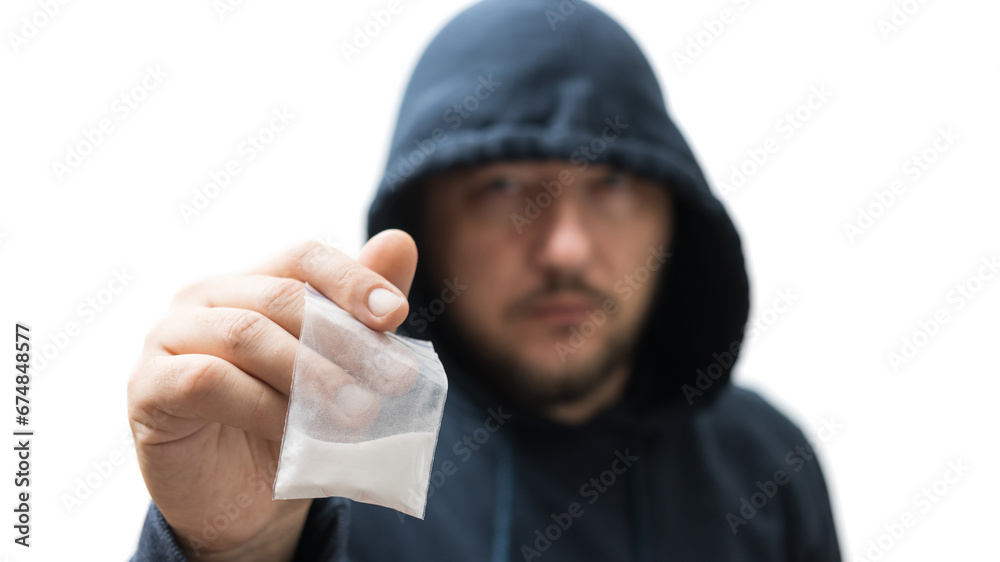 Criminal man in a hood holds transparent plastic bag with white powder hard drugs isolated on white background, drug dealer or gangster sells narcotics Criminal man in a hood holds transparent plastic bag with white powder hard drugs isolated on white background, drug dealer or gangster sells narcotics