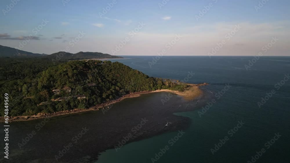 Amazing aerial top view of a tropical beach sunset, Golden hour on the blue sea Amazing aerial top view of a tropical beach sunset, Golden hour on the blue sea