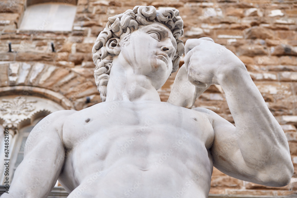 close-up from below of the copy of the statue of David by Michelangelo Buonarroti in Singoria square at the entrance of Palazzo Vecchio dei Medici in Florence
