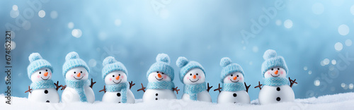 Little knitted snowmans on soft snow