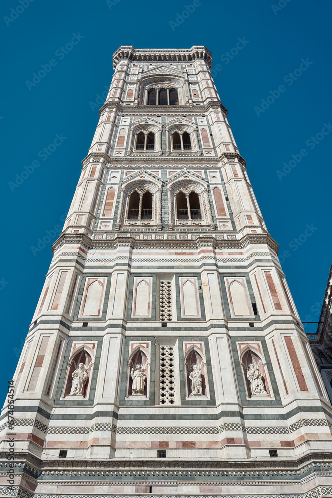 Giotto's bell tower seen from below with contrasting blue sky in Florence